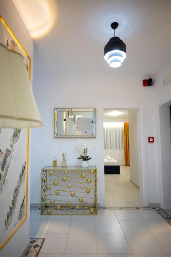 a living room with a dresser and a mirror at Frekel Hotel in Tirana