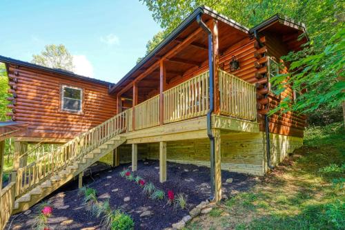 a log cabin with a staircase leading to a deck at Moonlight Waters by Pond in South Bloomingville