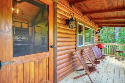 a porch of a wooden cabin with a rocking chair at Moonlight Waters by Pond in South Bloomingville