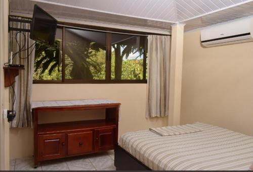 a small bedroom with a bed and a window at Centro Ecológico La Ribera-CABINA 5 in San Rafael