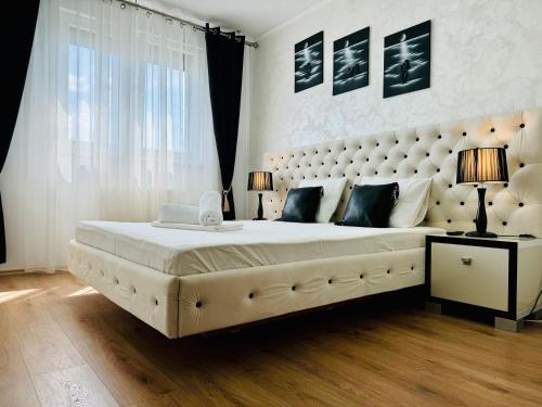 a bedroom with a large bed with a large headboard at Joy City Stay Forest 84 in Timişoara