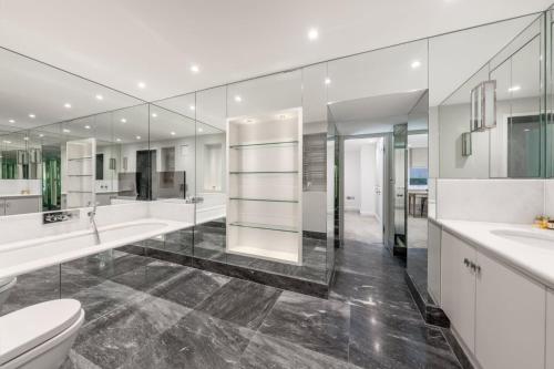 a bathroom with a toilet and two sinks and mirrors at Knightsbridge - Hans Place Apartments in London