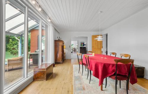 a dining room with a red table and chairs at 4 Bedroom Gorgeous Home In Varde in Varde