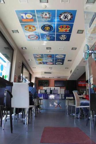 a restaurant with a ceiling with signs on it at Yiannis Apartments in Ioannina