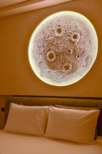 a bubble light hangs above a bed in a hotel room at Los Suites in Antalya
