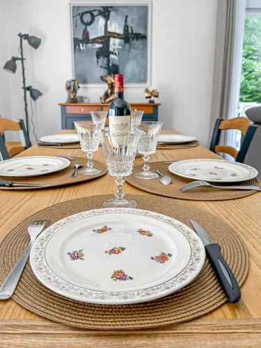 a table with a plate and a bottle of wine at Bords de Loire à Ancenis in Ancenis