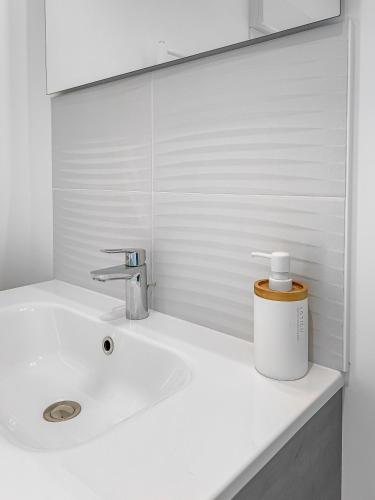 a white sink in a bathroom with a mirror at Bords de Loire à Ancenis in Ancenis