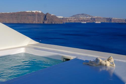 a starfish sitting on the edge of a boat in the water at Oia Treasures Art Suites in Oia