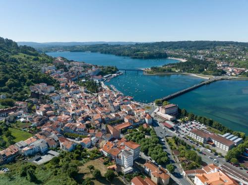 an aerial view of a city and a river at La Fantástica Pontedeume 4 in Puentedeume