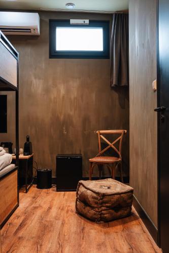a room with a chair and a ottoman at City Center Lodge Utrecht in Utrecht
