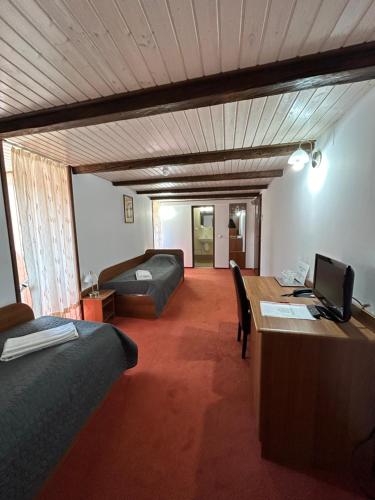 a room with a bed and a desk with a computer at Casa Weidner in Sibiu