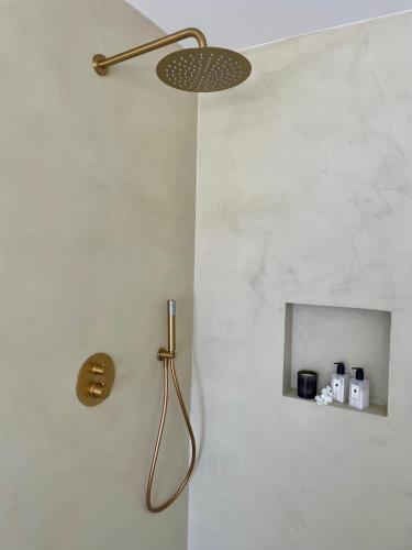 a shower in a bathroom with a shower head at Tierratlanta Suites in Zahara de los Atunes