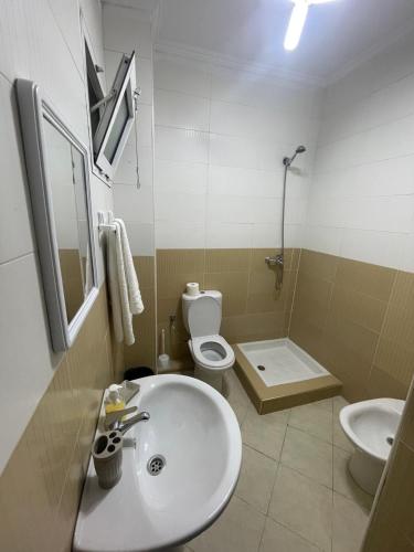 a bathroom with a sink and a toilet and a shower at Appartement Résidence Yassmina in Tangier