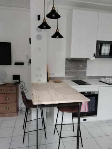 - une cuisine avec une table et deux chaises dans l'établissement Studio tout confort centre-ville, à Tarbes