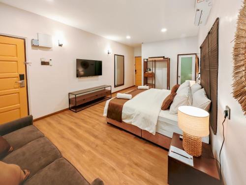 a hotel room with a bed and a couch at Mulyo Hotel in Port Dickson