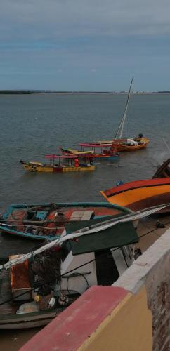 a group of boats sitting in the water at Pousada Tycoz Flor do mar in Galinhos