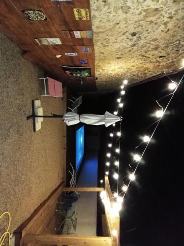 a white umbrella hanging from a ceiling with lights at chambre a bizanet in Bizanet