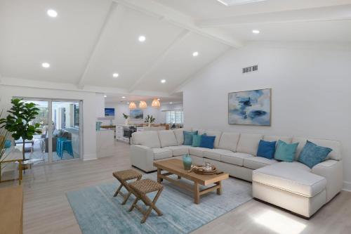 a living room with a couch and a table at Sea Glass Villa- Executive Pool Home on Golf Course in Sanibel