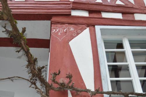 a window with a red cross on the side of a building at Ferienhaus Old Winery in Briedel