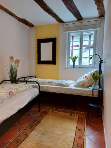 two beds in a room with a window at Ferienhaus Old Winery in Briedel