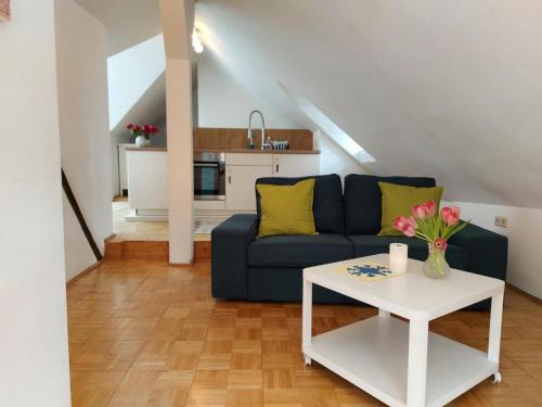 a living room with a blue couch and a table at Ferienhaus Old Winery in Briedel