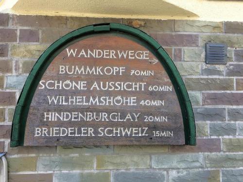 a sign on the side of a brick building at Ferienhaus Old Winery in Briedel