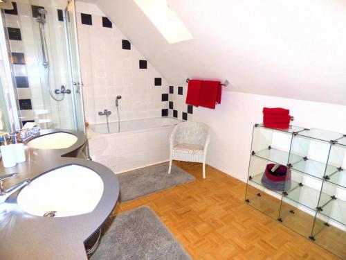 a bathroom with a sink and a bath tub at Ferienhaus Old Winery in Briedel