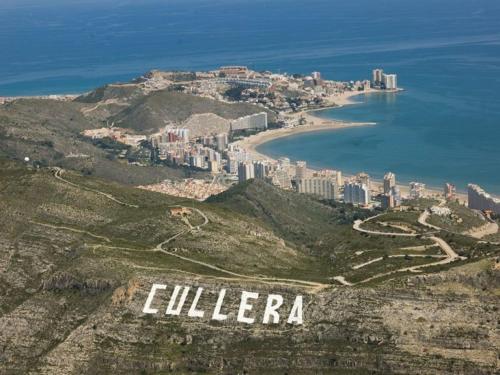 an aerial view of a city on a hill with the ocean at Amazing beach apartment in Cullera