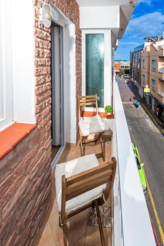 a balcony with two chairs and a table at Calas Beach Corralejo in Corralejo
