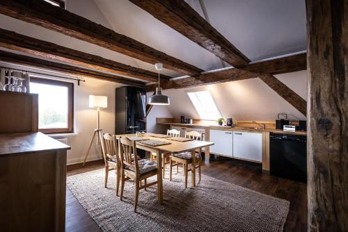 a kitchen with a table and chairs in a room at GH Maisonette Studio Whg 45 in Bastorf