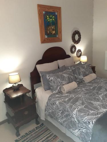 a bedroom with a bed and two lamps on a night stand at Kleinfontein in Clanwilliam
