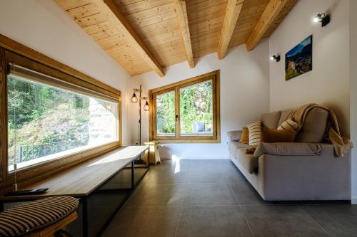 a living room with a couch and a window at Cal Periquet Rural in Ribes de Freser