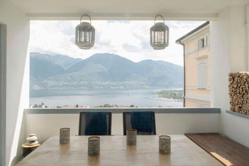 a room with a table and a large window at Casa Isabella App 2403 in Muralto