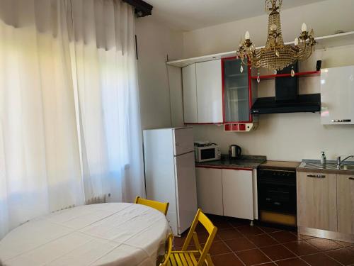 a small kitchen with a table and a refrigerator at Venice villa apartment in Mestre