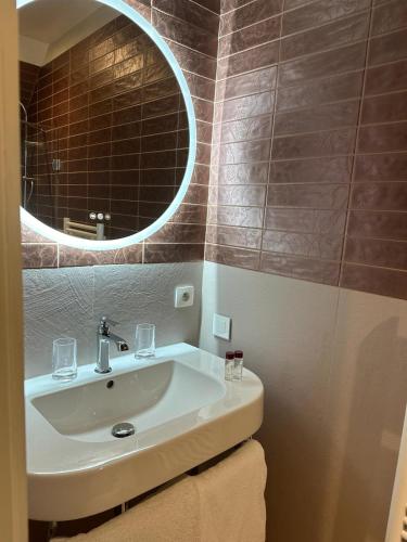 a bathroom with a sink and a mirror at Domaine De La Corniche in Rolleboise