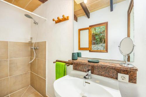 a bathroom with a sink and a shower and a mirror at La salve d´en Jordi in Pollença