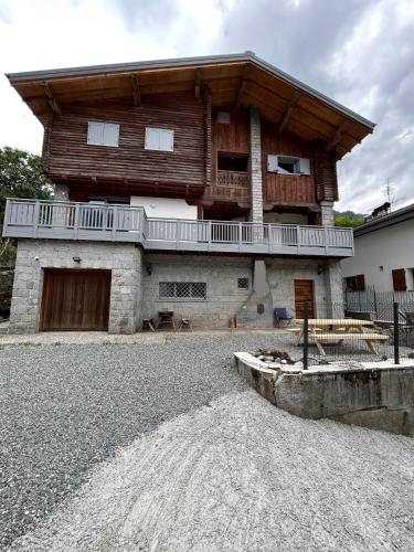 a large building with a balcony on top of it at Appartamento Chalet Bernardi in Caderzone Terme