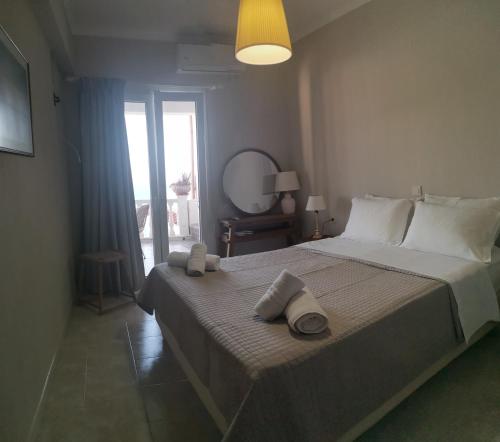 a bedroom with a large bed with towels on it at Avra in Parga