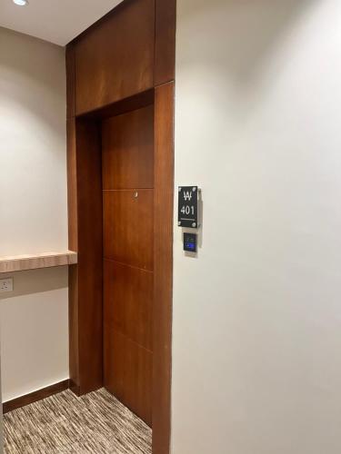 a elevator with a door with a sign on it at فندق دبليو سويتس - سما أبها in Abha