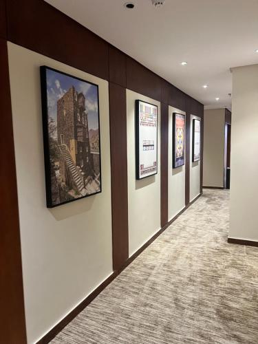 a hallway with pictures on the walls of a building at فندق دبليو سويتس - سما أبها in Abha