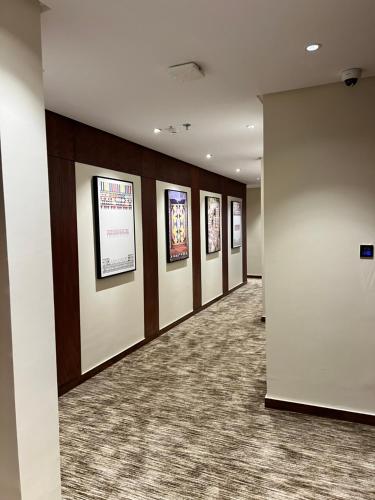 a hallway with a row of pictures on the wall at فندق دبليو سويتس - سما أبها in Abha
