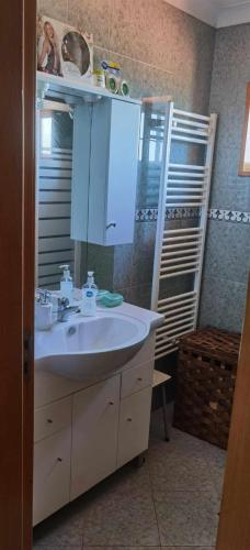 a bathroom with a sink and a mirror at La Casa de Marta in Ribeira de Pena