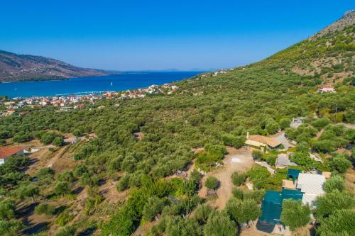 an aerial view of a small village on a hill next to a lake at Liodentro - Olea in Plataria