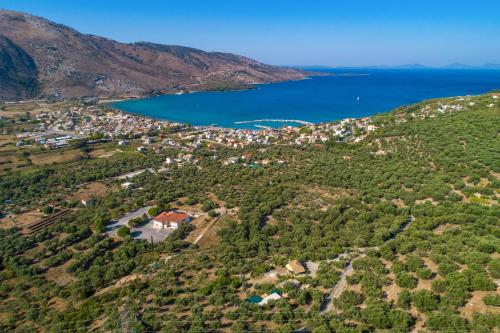 an aerial view of a small town on a hill next to a lake at Liodentro - Olea in Plataria