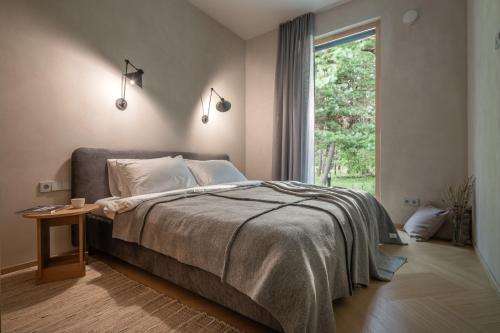 a bedroom with a large bed and a window at 50 meters to the Sea in Juodkrantė