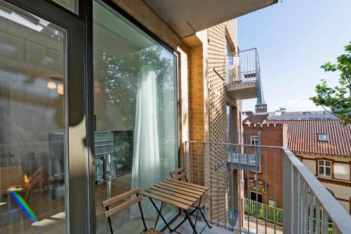 a balcony with a wooden bench and a window at Amazing 2BR w Balcony in the Heart of Aarhus City in Aarhus