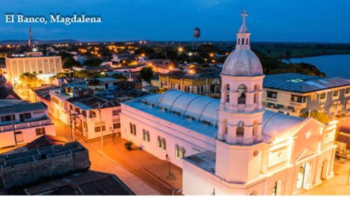 a large white building with a tower on top of it at Hotel Rio Grande 2 in El Banco