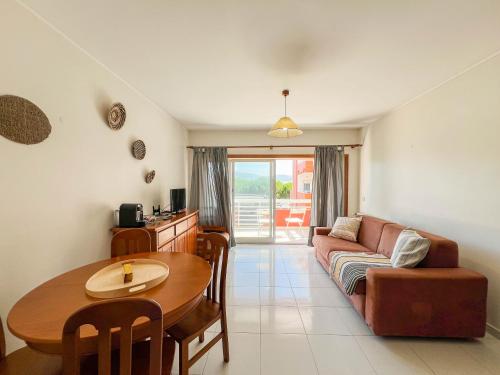 a living room with a couch and a table at Cabedelo Beach Condo in Viana do Castelo