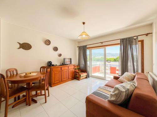a living room with a couch and a table at Cabedelo Beach Condo in Viana do Castelo