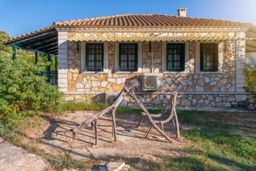 a house with a statue in front of it at Liodentro - Olea in Plataria